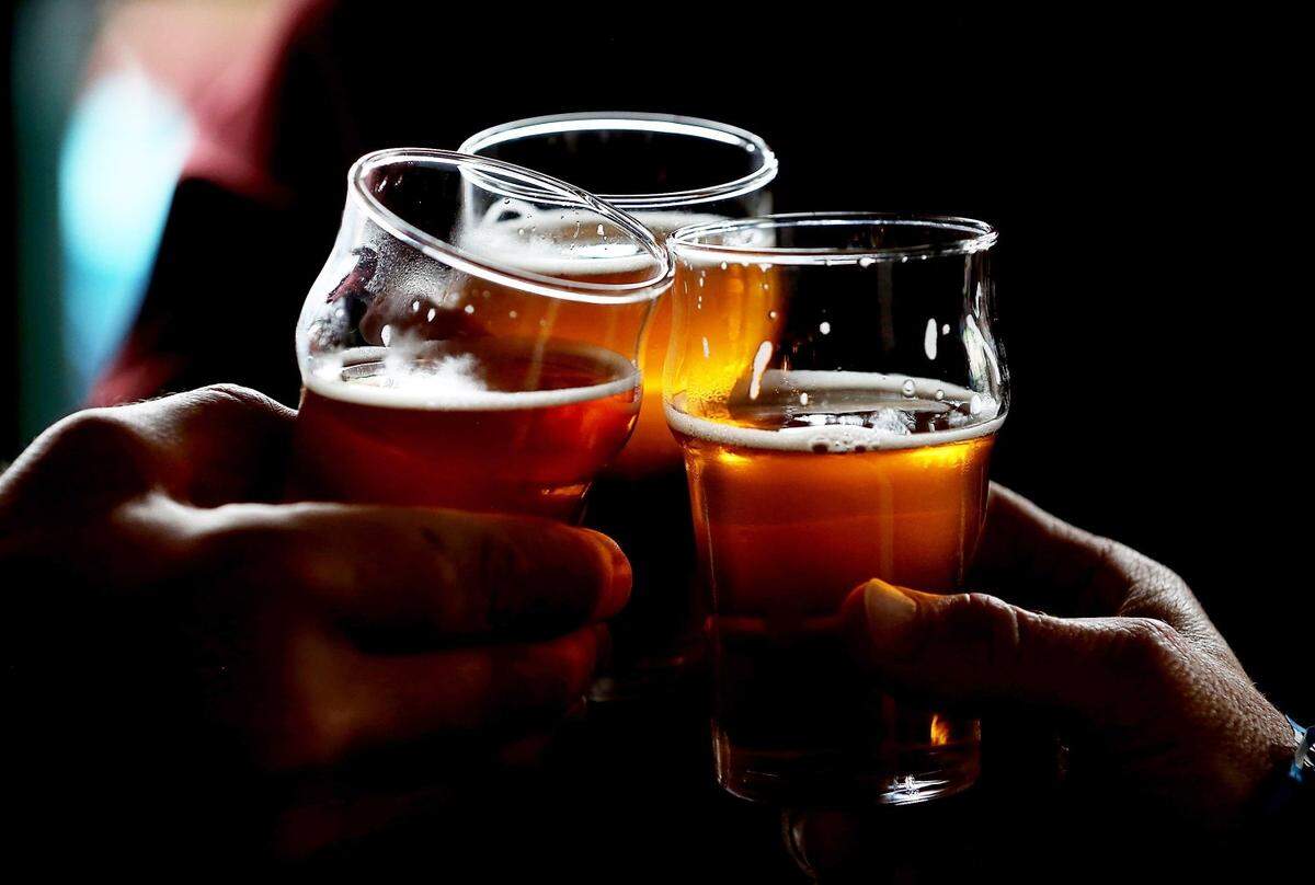 SANTA ROSA, CA - FEBRUARY 07:  Russian River Brewing Company customers clink their glasses while drinking the newly released Pliny the Younger triple IPA beer on February 7, 2014 in Santa Rosa, California.  Hundreds of people lined up hours before the opening of Russian River Brewing Co. to taste the 10th annual release of the wildly popular Pliny the Younger triple IPA beer that will only be available on tap from February 7th through February 20th. Craft beer aficionados rank Pliny the Younger as one of the top beers in the world. The craft beer sector of the beverage industry has grown from being a niche market into a fast growing 12 billion dollar business, as global breweries continue to purchase smaller regional craft breweries such this week's purchase of New York's Blue Point Brewing by AB Inbev.  (Photo by Justin Sullivan/Getty Images)