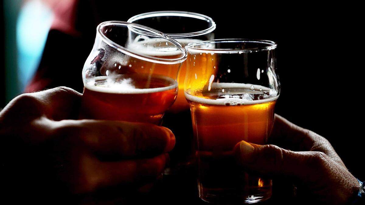 SANTA ROSA, CA - FEBRUARY 07:  Russian River Brewing Company customers clink their glasses while drinking the newly released Pliny the Younger triple IPA beer on February 7, 2014 in Santa Rosa, California.  Hundreds of people lined up hours before the opening of Russian River Brewing Co. to taste the 10th annual release of the wildly popular Pliny the Younger triple IPA beer that will only be available on tap from February 7th through February 20th. Craft beer aficionados rank Pliny the Younger as one of the top beers in the world. The craft beer sector of the beverage industry has grown from being a niche market into a fast growing 12 billion dollar business, as global breweries continue to purchase smaller regional craft breweries such this week's purchase of New York's Blue Point Brewing by AB Inbev.  (Photo by Justin Sullivan/Getty Images)