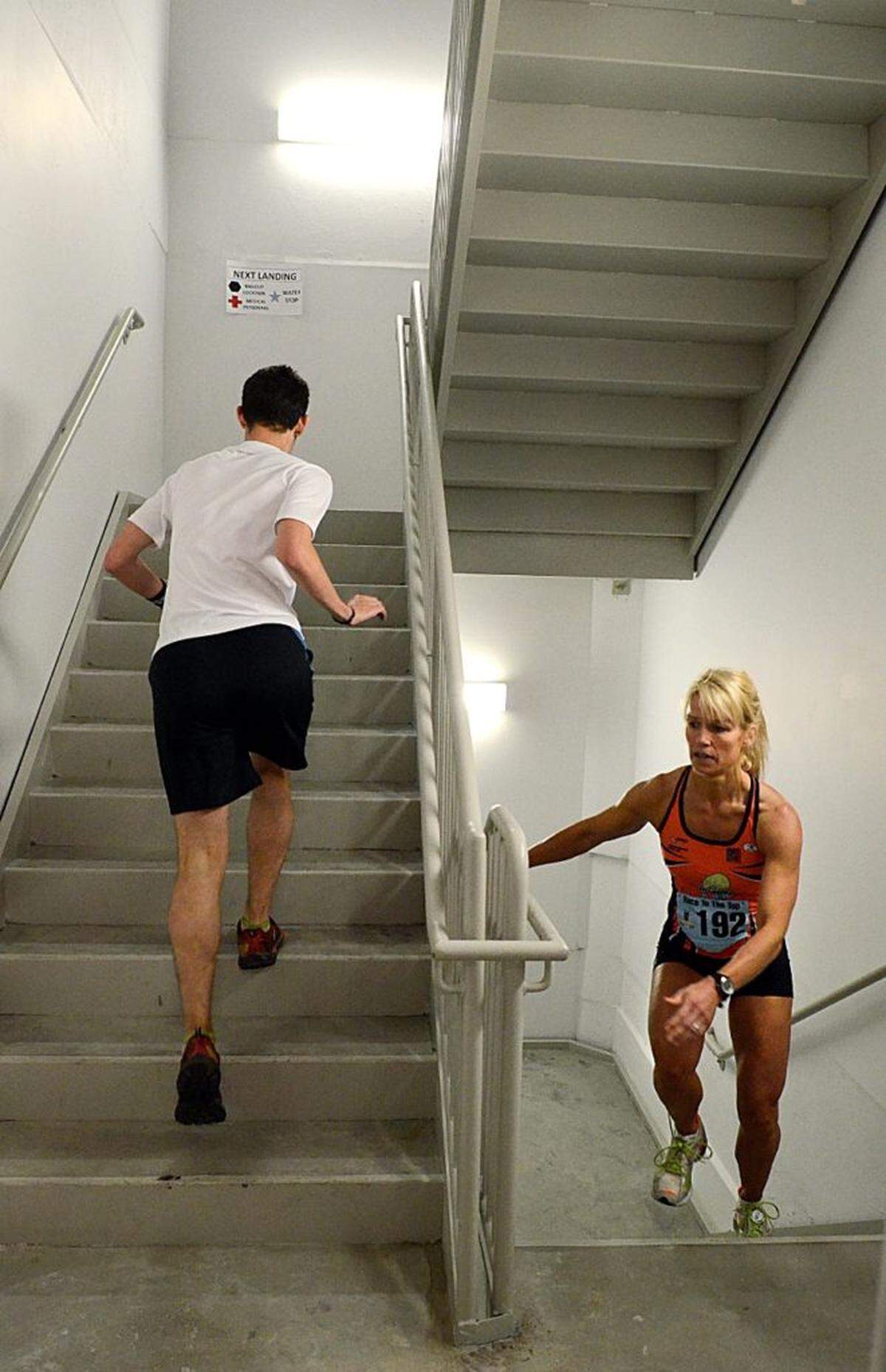 Stephanie Hucko (right), 40, of Charlotte, powers past the 49th  floor one level from her destination during the Race to the Top Saturday.__  About 510 climbers took the chance to beat down gravity and race to the top of the Duke Energy Center's 50th floor, as they compete against the clock. This years' Race To The Top happened on Saturday, March 24, 2012. The first climbers started at 8:30 am. John D. Simmons - jsimmons@charlotteobserver.com