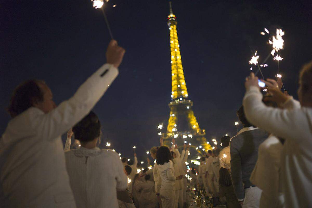 The Eiffel Tower is taller than the Bank of America tower by about a hundred feet. It remains unclear if the French (seen here in white) are celebrating that fact.