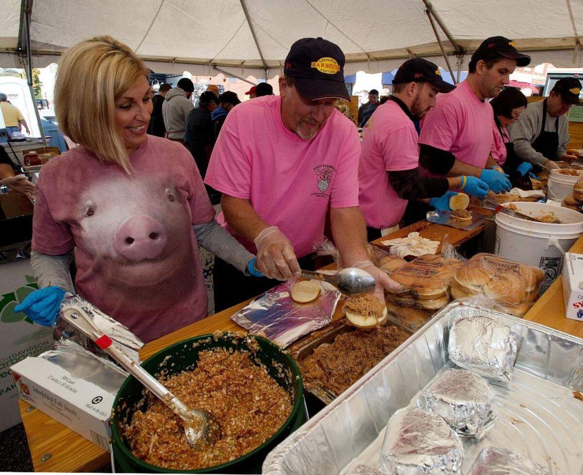 Speedy's Barbecue workers make barbecue sandiwches in one of the barbecue tents during the 30th Annual Barbecue Festival in Lexington on Saturday.