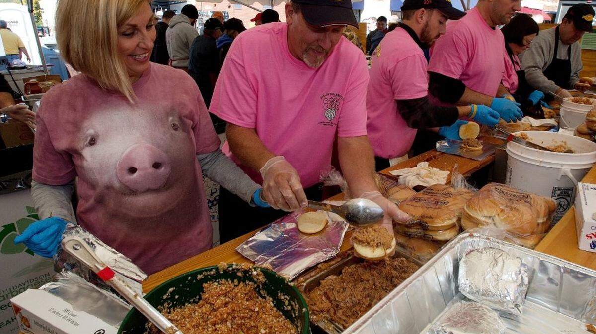 Speedy's Barbecue workers make barbecue sandiwches in one of the barbecue tents during the 30th Annual Barbecue Festival in Lexington on Saturday.