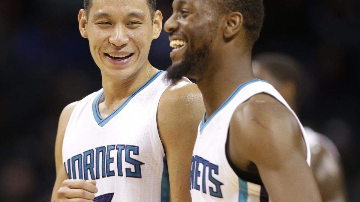 Charlotte Hornets' Jeremy Lin (7) and Kemba Walker (15) share a laugh in the second half of an NBA preseason basketball game against the Chicago Bulls in Charlotte, N.C., Monday, Oct. 19, 2015. The Hornets won 94-86. (AP Photo/Chuck Burton)
