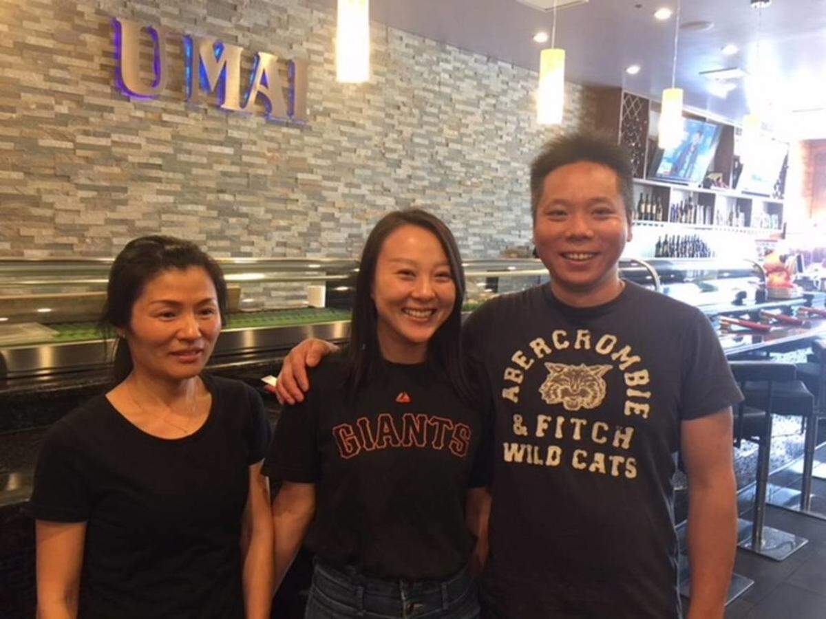 Servers Lucy Li (left) and Lisa Li (no relation) and Chuan Wang Fu owner Fang Jiang in front of the Umai Sushi side of the restaurant.Photo by Kathleen Purvis