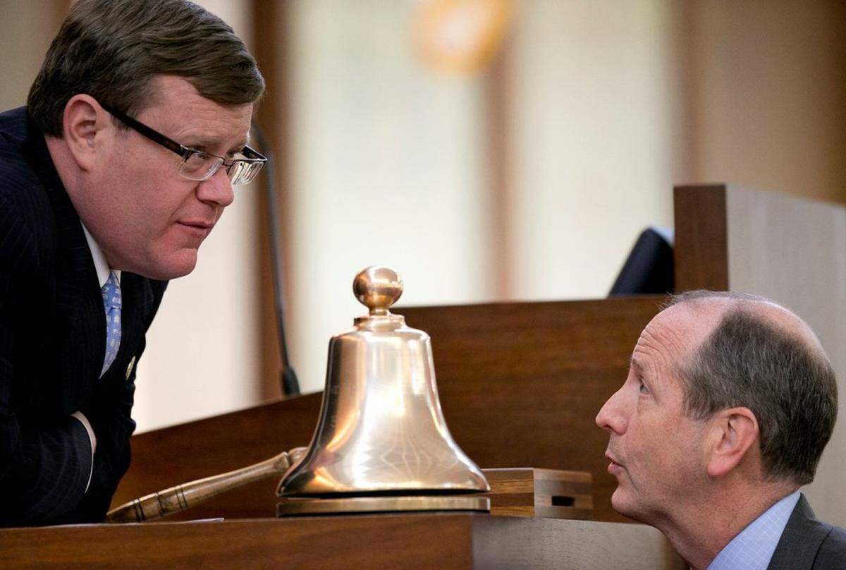 House Speaker Tim Moore talks with bill sponsor Rep. Dan Bishop of Mecklenburg County, right during debate of House Bill 2 on the House floor.