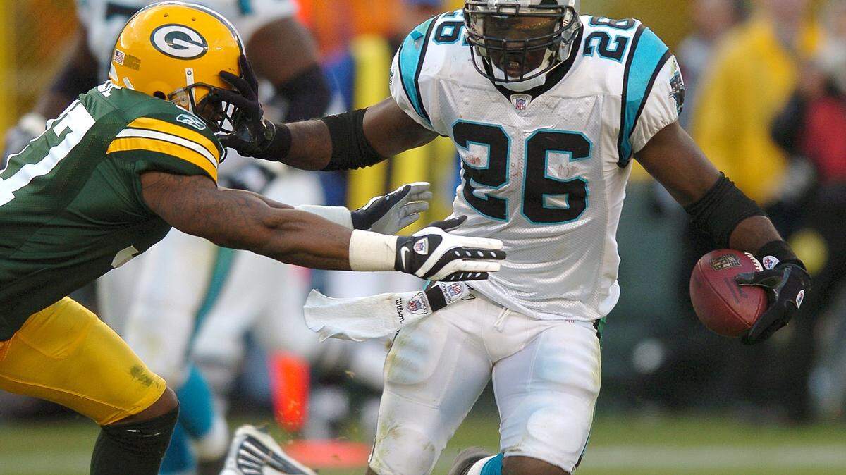 11/18/07 Carolina Panthers (26) running back DeShaun Foster pushes a Green Bay Packers defender to the side during fourth quarter action Sunday vs the Green Bay Packers at Lambeau Field in Green Bay, WI.  The Green Bay Packers defeated the Carolina Panthers 31-17. JEFF SINER -- jsiner@charlotteobserver.com
