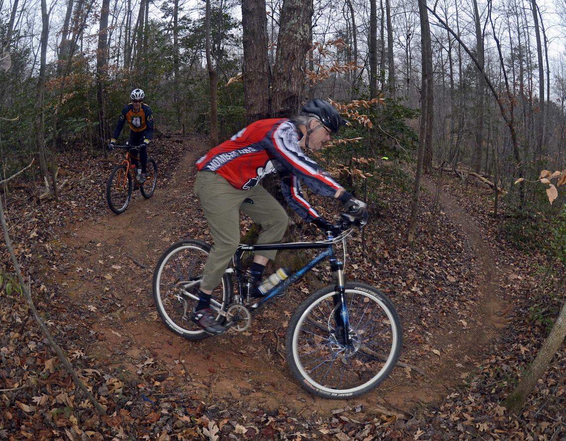 Bikers navigate the Itusi Trail at Lake Norman State Park in Troutman.