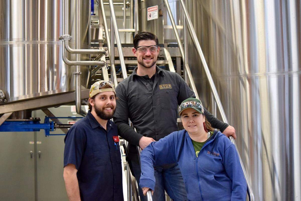 Chad Henderson, Co-Owner and Head Brewer; Matt Virgil, Lead Brewer; and Rachel Cardwell, Assistant Brewer.