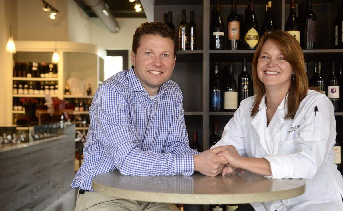 Mark Meissner and Casey Hickey are married and together they run Petit Philippe, a wine and chocolate shop and tasting room on Selwyn Ave. Mark oversees the wine operation, while Casey, a certified pastry chef who studied in France, handles the chocolate. The couple posed for a portrait on Thursday February 6, 2014.