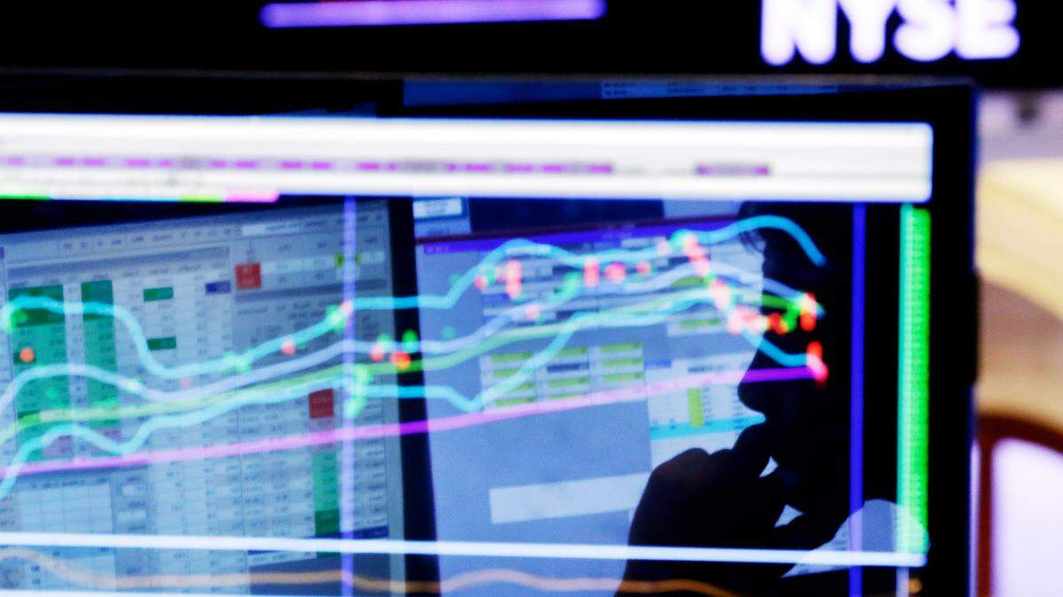FILE - In this Monday, Jan. 11, 2016, file photo, specialist Anthony Rinaldi is silhouetted on a screen at his post on the floor of the New York Stock Exchange. A smoother ride for stock investors sounds like a no-brainer given this year’s big swings for the stock market, but the “low-volatility” funds pitched by the investment industry come with their own risks. (AP Photo/Richard Drew, File)