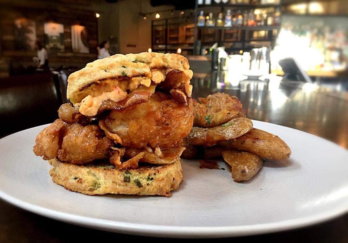 Crispy chicken on a buttermilk biscuit, pimento cheese, smoked bacon and breakfast potatoes is one of the favorites on the brunch menu at WP Kitchen + Bar at Phillips Place. Courtesy of WP Kitchen
