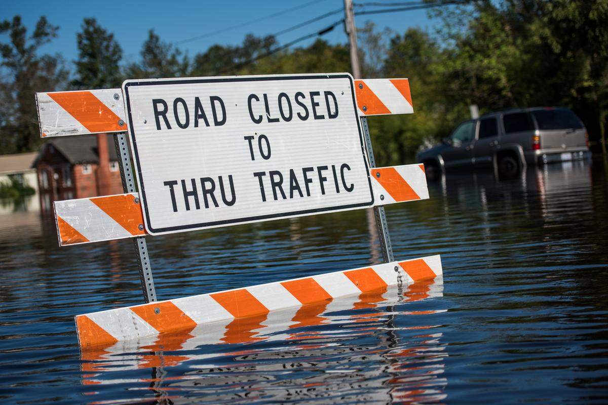 LUMBERTON, NC - OCTOBER 12: Floodwaters from the Lumber River surround a traffic sign on October 12, 2016 in Lumberton, North Carolina. Hurricane Matthew's heavy rains ended over the weekend, but flooding is still expected for days in North Carolina. (Photo by Sean Rayford/Getty Images)