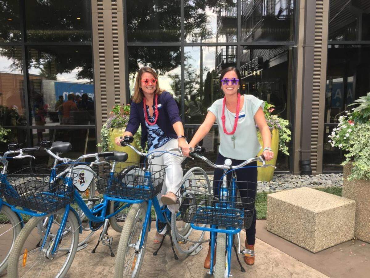 Spectrum Southend Apartment Community Manager Nicole Hamber and her assistant Alexandra Payne with the complex’s bike cruisers, free for residents to use.