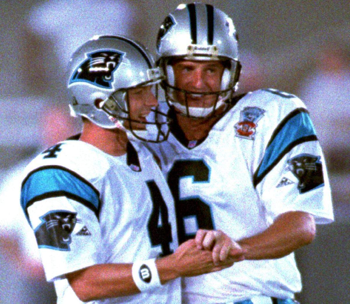Tommy Barnhardt (right) punted for the Carolina Panthers in their inaugural 1995 season and also played two seasons in Washington.