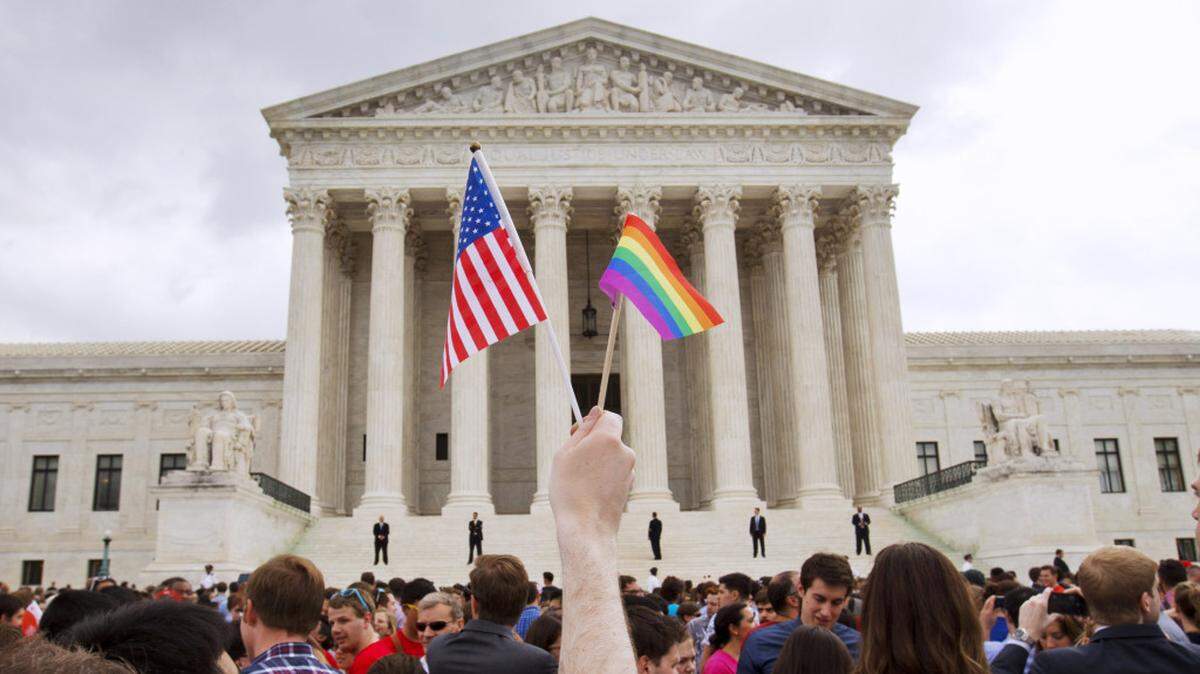 In this June 26, 2015 file photo, a crowd celebrates the Obergefell v. Hodges decision outside the Supreme Court building in Washington after the court declared that same-sex couples have a right to marry anywhere in the U.S.