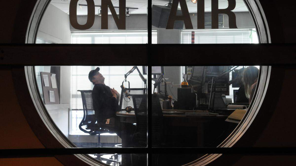 (01.29.10) Rob Tanner (CQ, leaning back in chair during his show), WSOC's "morning show  personality" and Pinkie (CQ, that's all she goes by, she's barley visible on the right ithrough the window), his sidekick and Chris Allen (CQ, not in photo), producer of the "Tanner in the morning" show.  JOHN D. SIMMONS -jsimmons@charltteobserver.com