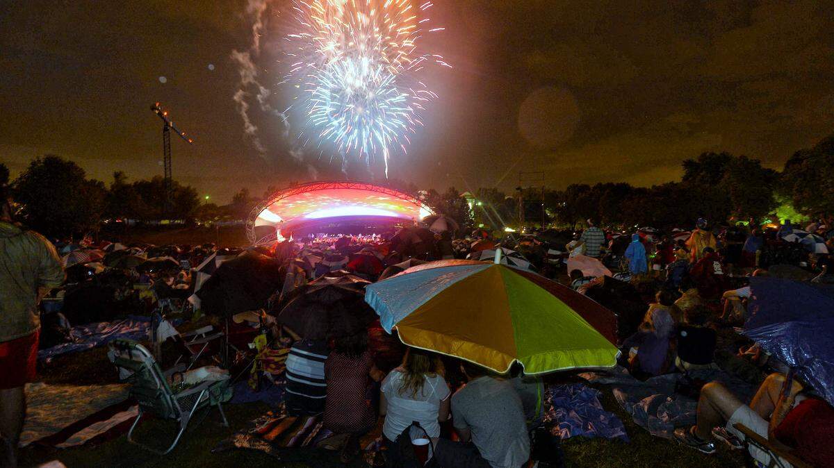 Fireworks light up the sky  during Summer Pops "Celebrate America!" concert at Symphony Park,SouthPark on Thursday July 3,2014. The Liberty Fanfare, Armed Forces Salute, This Land is Your Land, and America the Beautiful were among the spirited patriotic pieces the Symphony performed  for Independence Day. Fireworks end the show.
