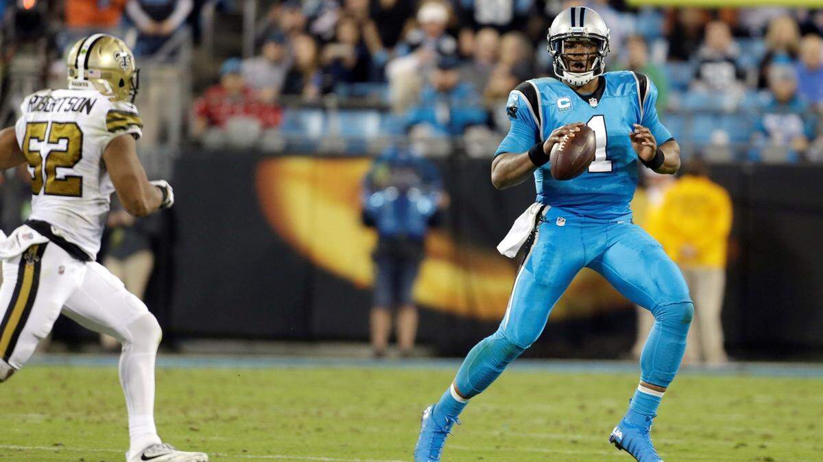 Carolina Panthers' Cam Newton (1) looks for an open receiver as he scrambles away from New Orleans Saints' Craig Robertson (52) during the second half of an NFL football game in Charlotte, N.C., Thursday, Nov. 17, 2016. The Panthers won 23-20.(AP Photo/Bob Leverone)