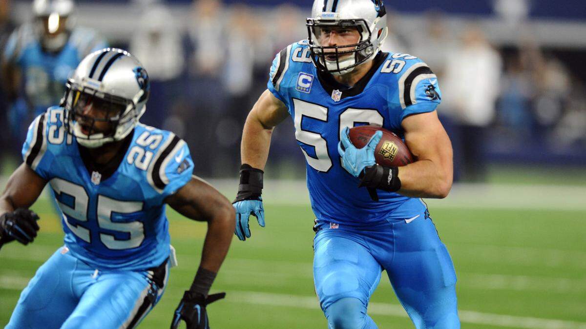 Carolina Panthers' Luke Kuechly (59) heads upfield to score a touchdown after intercepting a Dallas Cowboys' Tony Romo (9) pass in the second quarter at AT&amp;T Stadium on Thursday, November 26, 2015.  The Panthers won  33-14  and improved to 11-0.