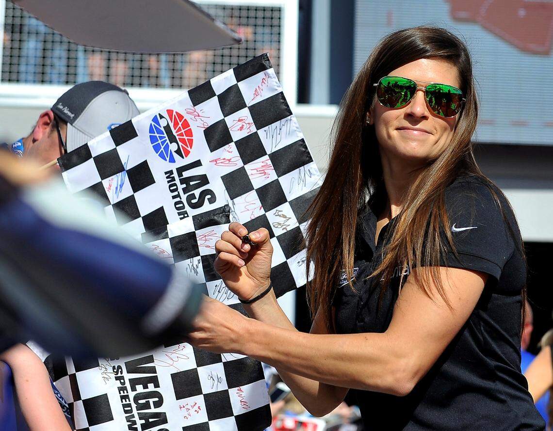 Danica Patrick signs autographs before a NASCAR Cup Series auto race Sunday, March 12, 2017, in Las Vegas. (AP Photo/David Becker)