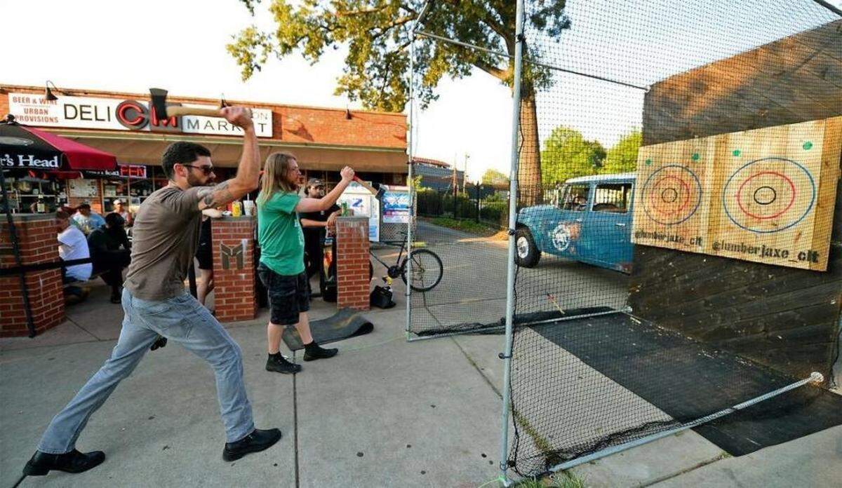 Patrons of the Common Market in Plaza Midwood were able to test their ability to throw an axe during a mobile event hosted Lumberjaxe on Thursday.