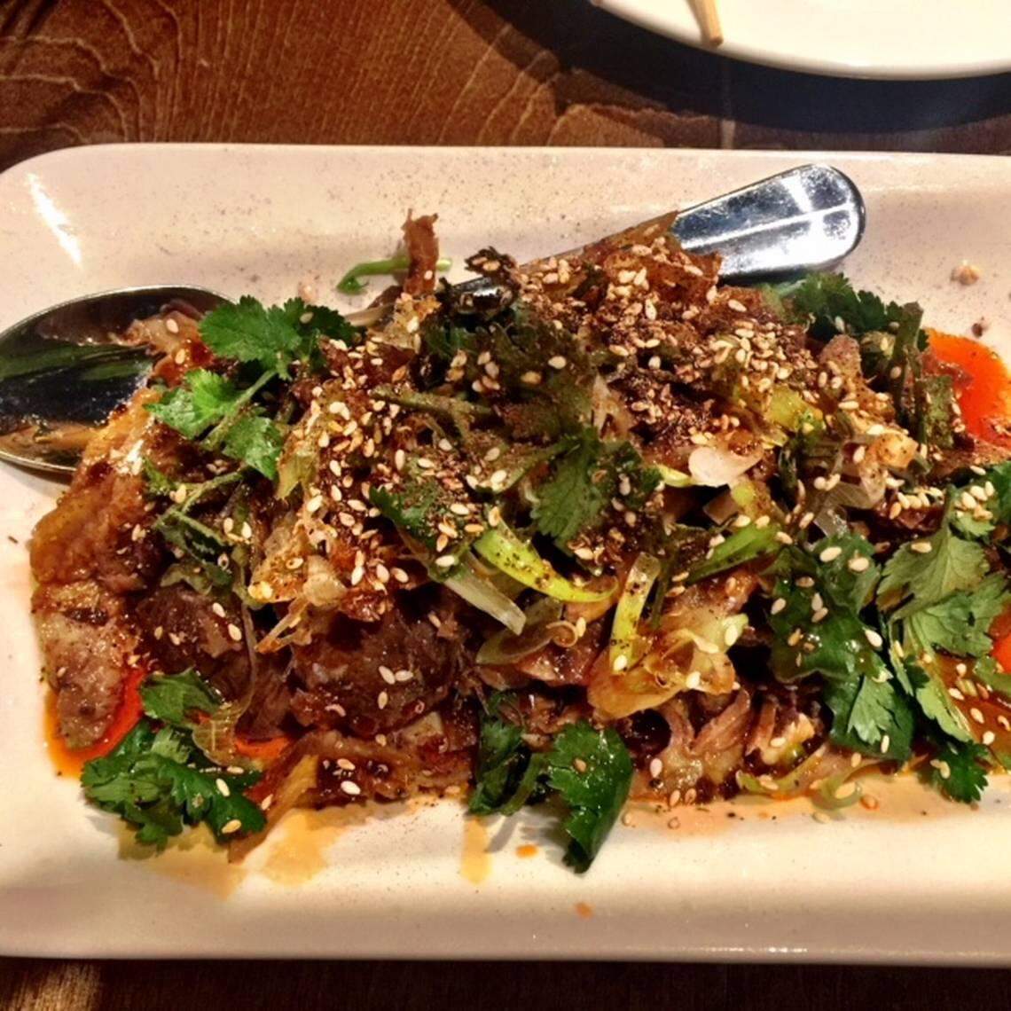 At Lam’s Kitchen, beef tendon and tripe is tender and served cold in a fiery mixture of hot chile oil, sesame seeds and cilantro.