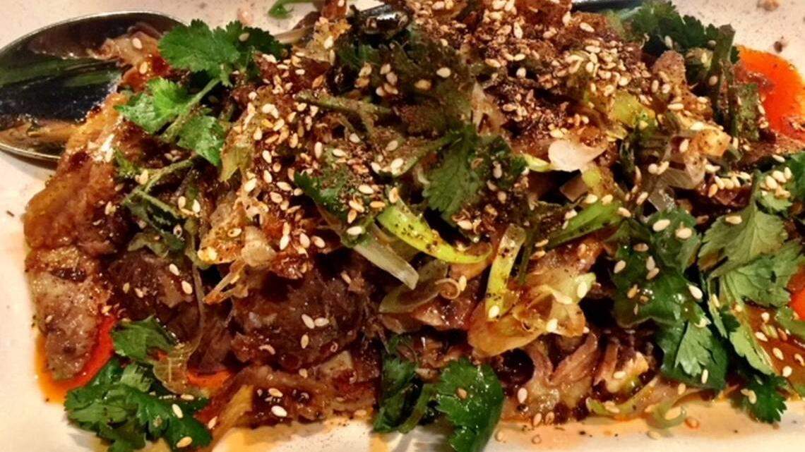 At Lam's Kitchen, beef tendon and tripe is tender and served cold in a fiery mixture of hot chile oil, sesame seeds and cilantro.
Photo by Kathleen Purvis