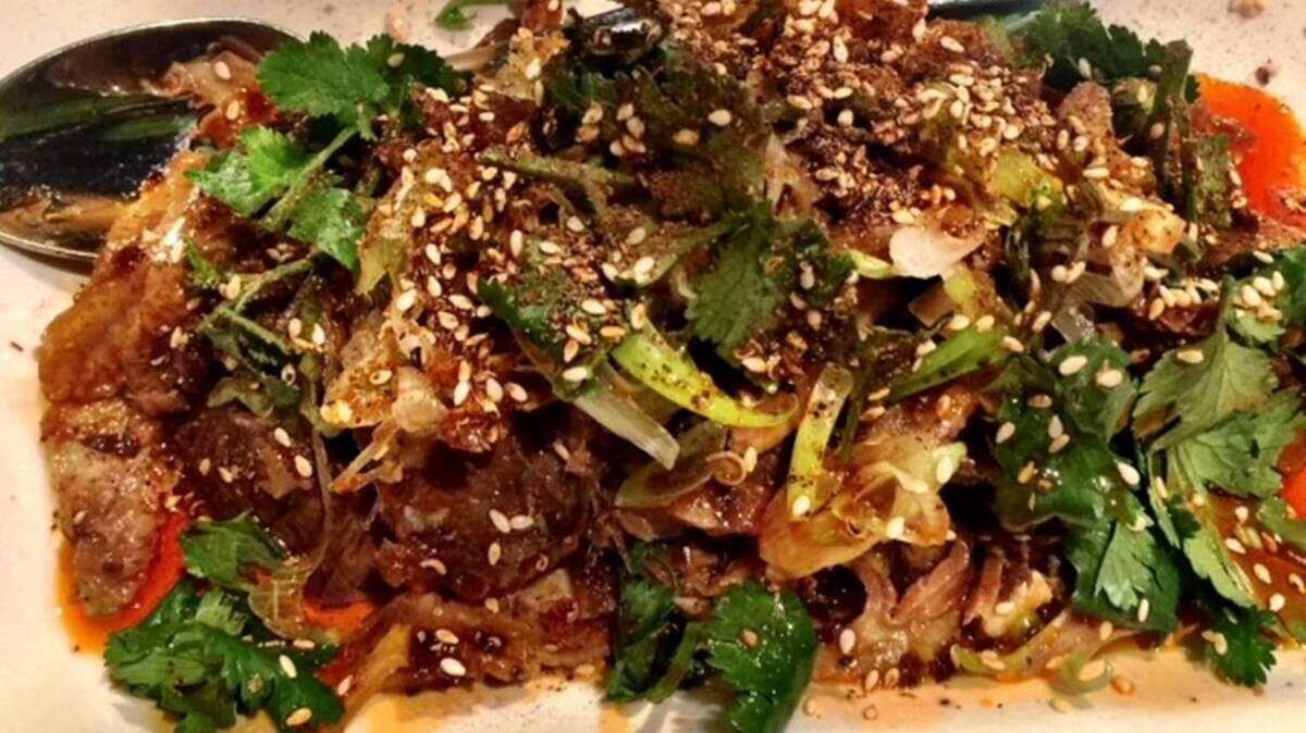 At Lam's Kitchen, beef tendon and tripe is tender and served cold in a fiery mixture of hot chile oil, sesame seeds and cilantro.
Photo by Kathleen Purvis