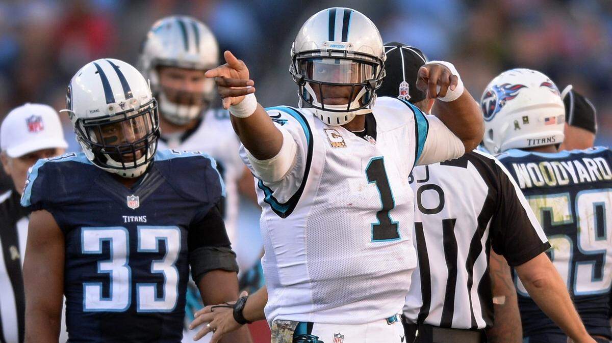 Carolina Panthers quarterback Cam Newton signals a first down after rushing vs the Tennessee Titans during fourth quarter action at Nissan Stadium in Nashville, TN. on Sunday, November 15, 2015. The Panthers defeated the Titans 27-10.