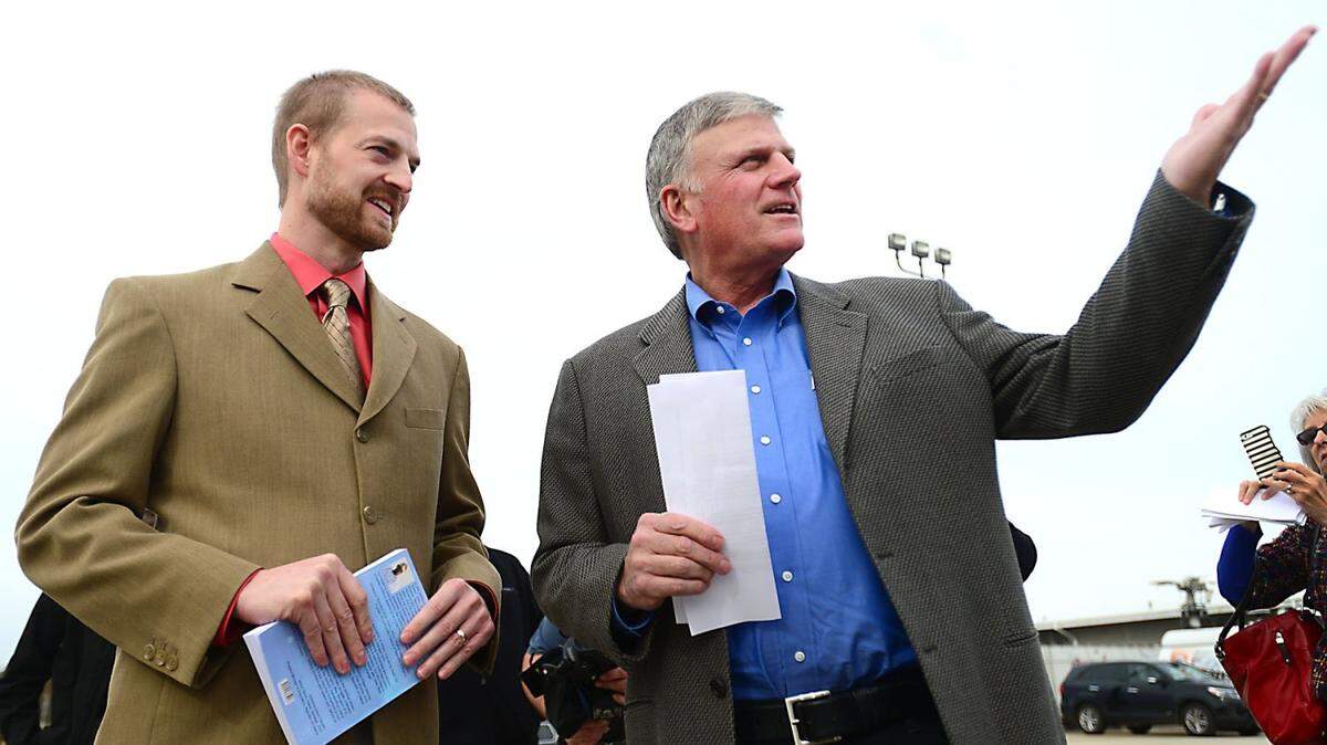 Ebola survivor, Dr. Kent Brantley, left, talks with Franklin Graham at Charlotte Douglas International Airport  Wednesday, Nov. 5, 2014. Samaritan's Purse loaded a cargo jet with more than 100 tons of Ebola relief supplies.