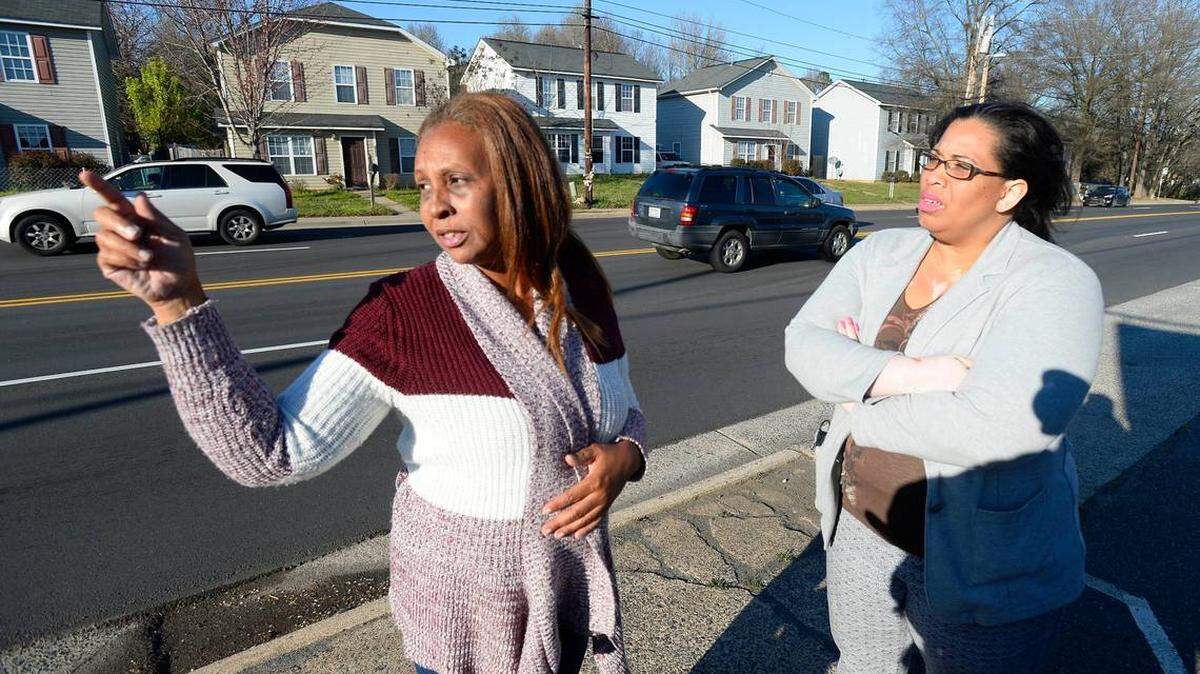 Mary Fryar, left, talks about the traffic along West Boulevard as Amy Anderson listens on March 7, 2018. Fryar lost her middle child, Ty'Asia Young, 11, who was killed while trying to cross West Boulevard after a trip to a convenience store. The boulevard has four lanes, and there is no "island" separating traffic to give pedestrians safety.
Photo by David T. Foster III dfoster@charlotteobserver.com