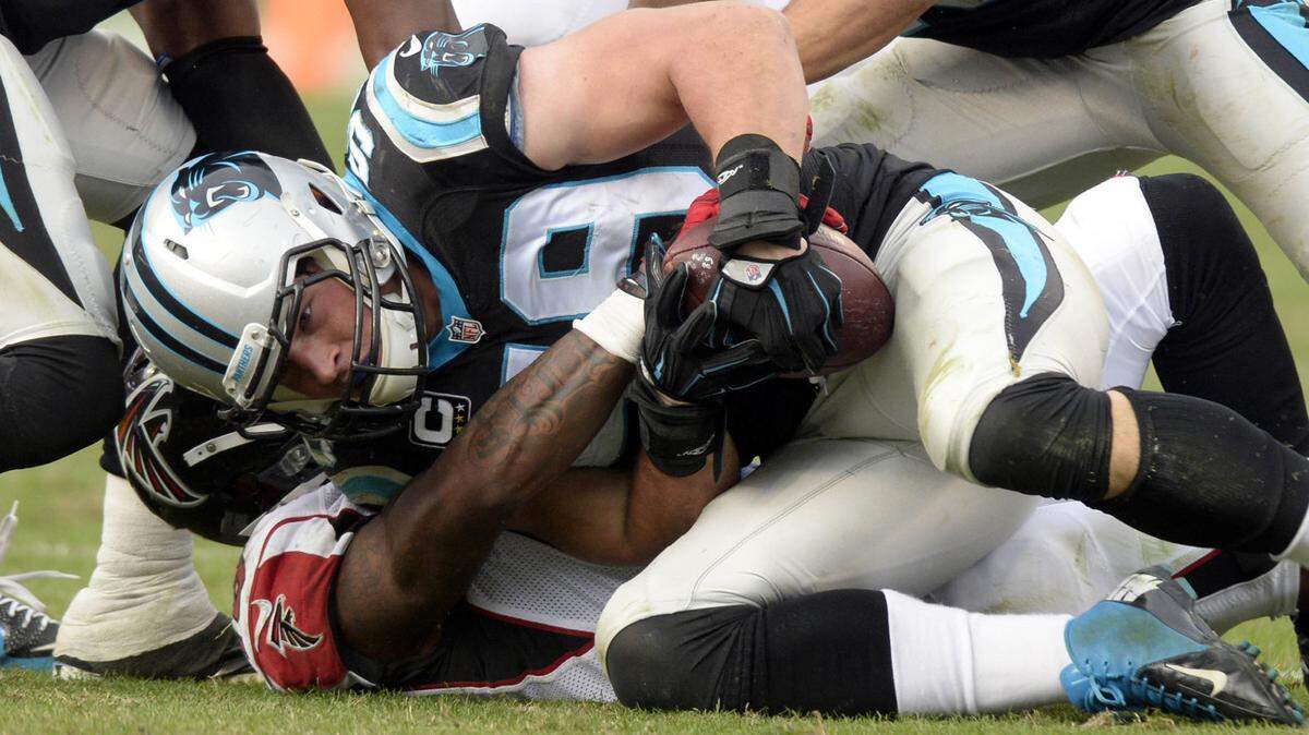 Carolina Panthers' Luke Kuechly (59) secures an interception of an Atlanta Falcons pass during the third quarter on Sunday, Dec. 13, 2015, at Bank of America Stadium in Charlotte, N.C. (David T. Foster III/Charlotte Observer/TNS)