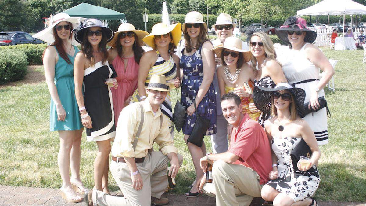 Young professionals in their race day finery on the lawn of the Mint Museum Randolph during the Young Affiliates of the Mint Museum's annual Derby Days fundraiser.