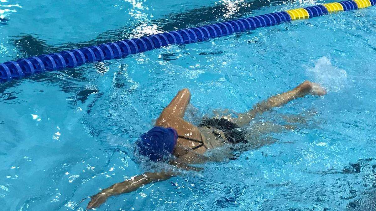 Photo by Kristi Sturgill<br/>Mecklenburg resident Julianna Jones swims freestyle at Mecklenburg County Aquatic Center. Daily rates at county indoor pools approximately doubled on Monday.