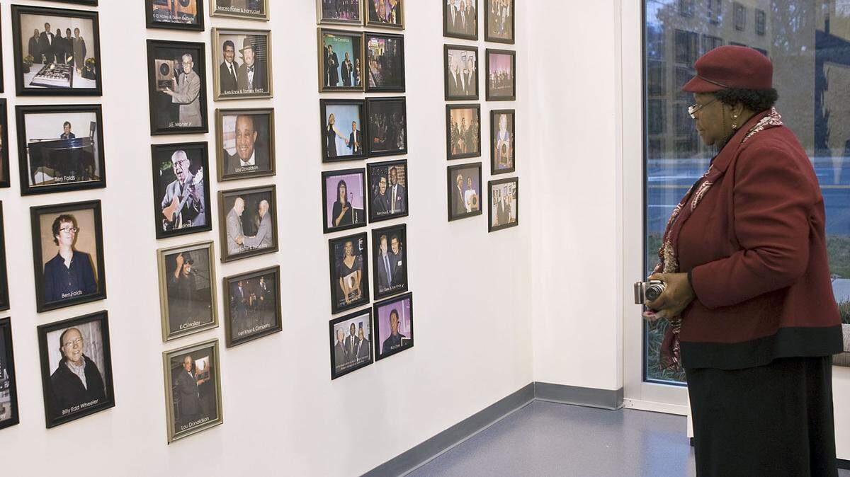 Ruth Brooks of Concord looks at the wall of inductees during the NC Music Hall of Fame preview on Dec. 4th.  Brooks is excited about bringing youth from the Multi-cultural Community Student Union to the new location at 600 Dale Earnhardt Blvd. in Kannapolis.  12-04-14  Reopening of the NC Music Hall of Fame at their new location, 600 Dale Earnhardt Blvd. in Kannapolis.