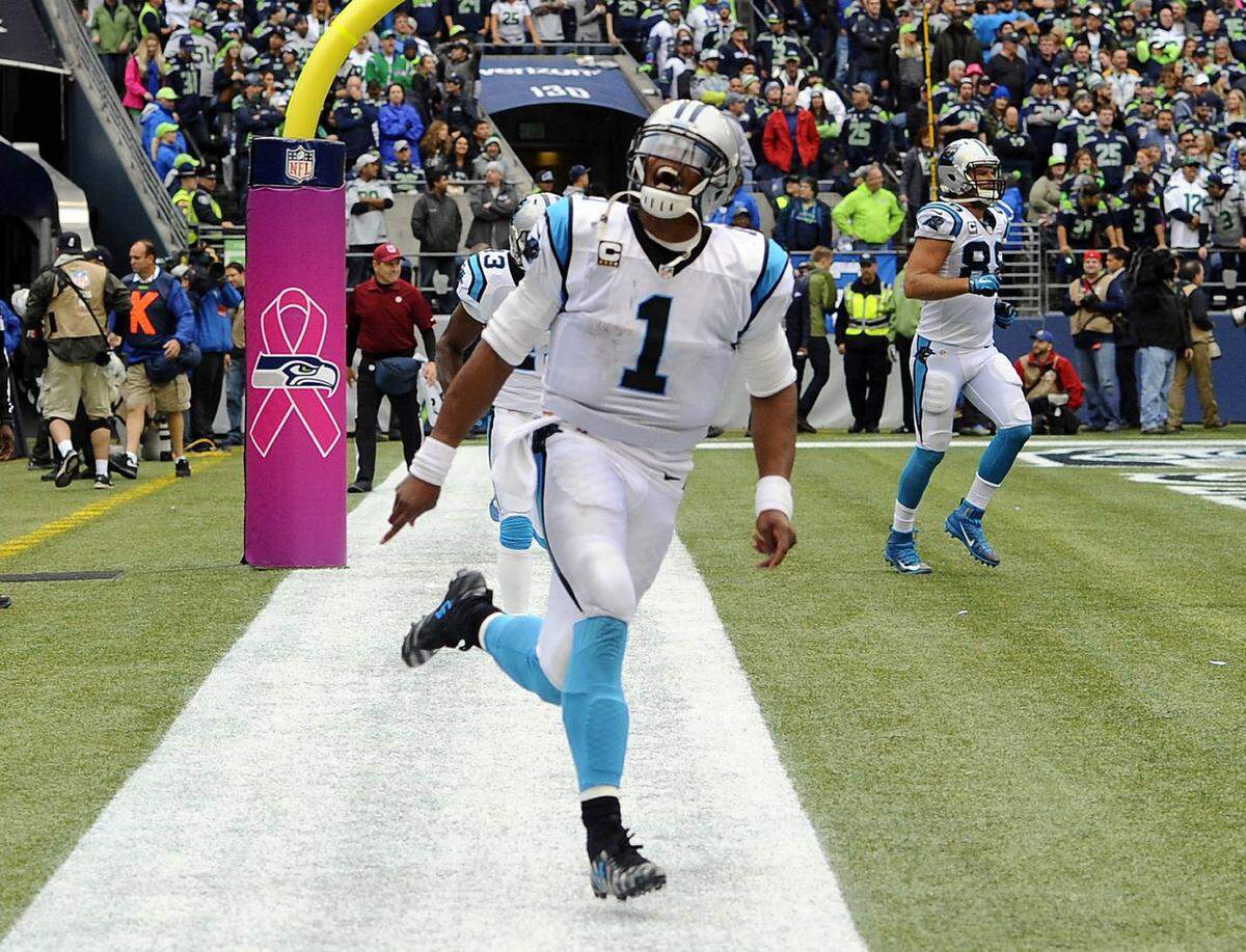 Carolina Panthers’ Cam Newton (1) celebrates throwing a game-winning touchdown to Greg Olsen (88) against Seattle in 2015, the year he was named the NFL’s Most Valuable Player.