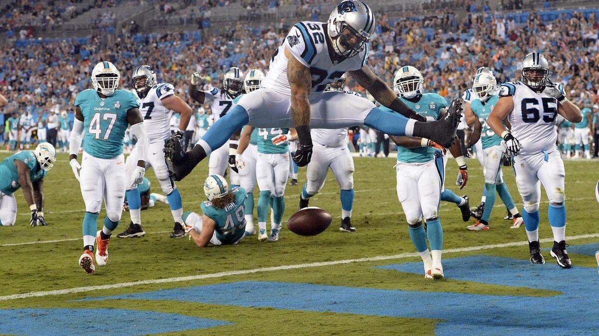 Carolina Panthers' Brandon Wegher (32) scores a touchdown past the Miami Dolphins defense in the third quarter during their preseason game at Bank of America Stadium on Saturday, August 22, 2015. The Panthers won, 31-30.