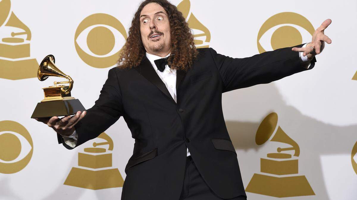 "Weird Al" Yankovic poses in the press room with the award for best comedy album for "Mandatory Fun" at the 57th annual Grammy Awards at the Staples Center on Sunday, Feb. 8, 2015, in Los Angeles. (Photo by Chris Pizzello/Invision/AP)