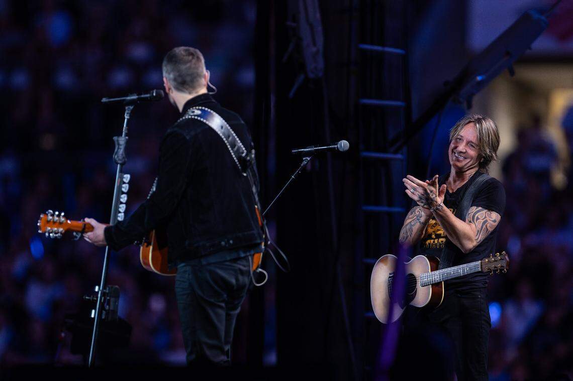 Eric Church, left, sings Happy Birthday to Keith Urban during Concert for Carolina in Charlotte, N.C. on Saturday, October 26, 2024.