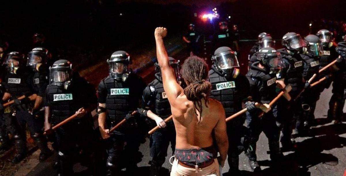 Photo by Jeff Siner / Charlotte Observer<br/> Braxton Winston, protester during the 2016 protests after the police shooting death of Keith Scott, now has a seat on Charlotte City Council. This photo is on display at the Levine Museum of the New South.