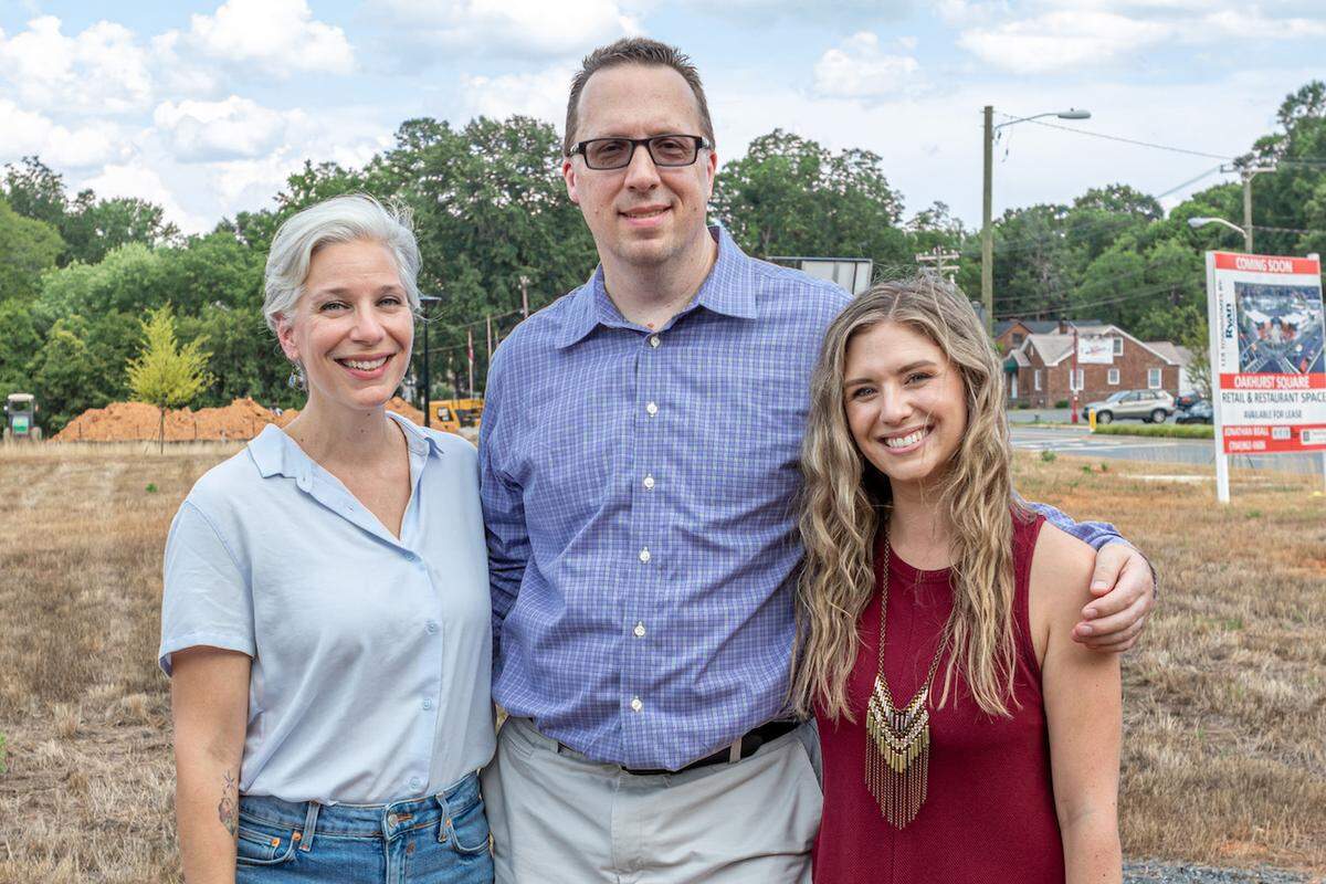 NoDa Yoga co-owners Jillian Longsworth and Craig Rasmussen, and studio manager Jenny Eickmeyer, standing at the site of the Oakhurst location when it was under construction in 2019.