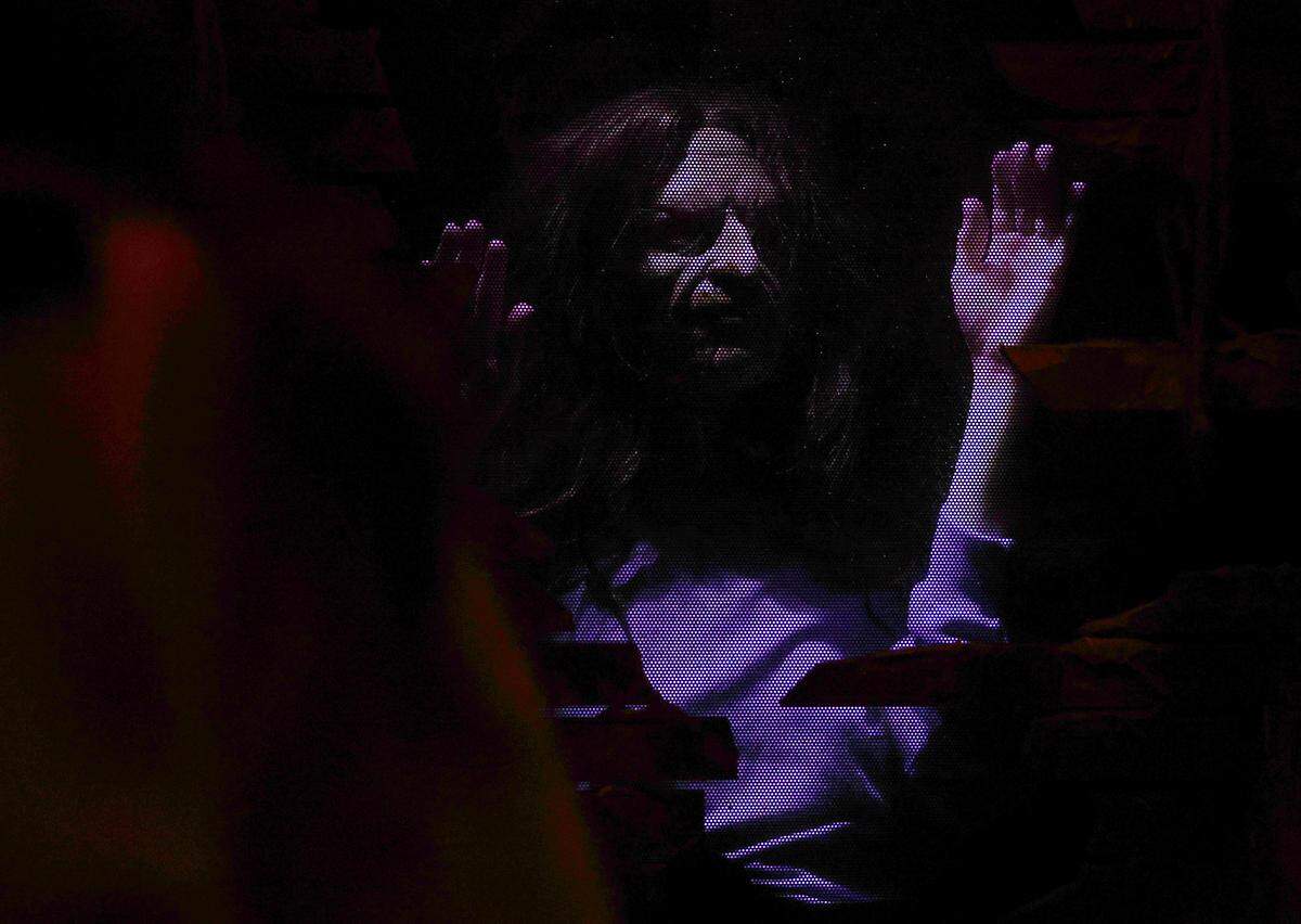 A creature jumps out at a crowd at The Conjuring: Beyond Fear experience at Scarowinds on Tuesday, Sept. 9, 2025.