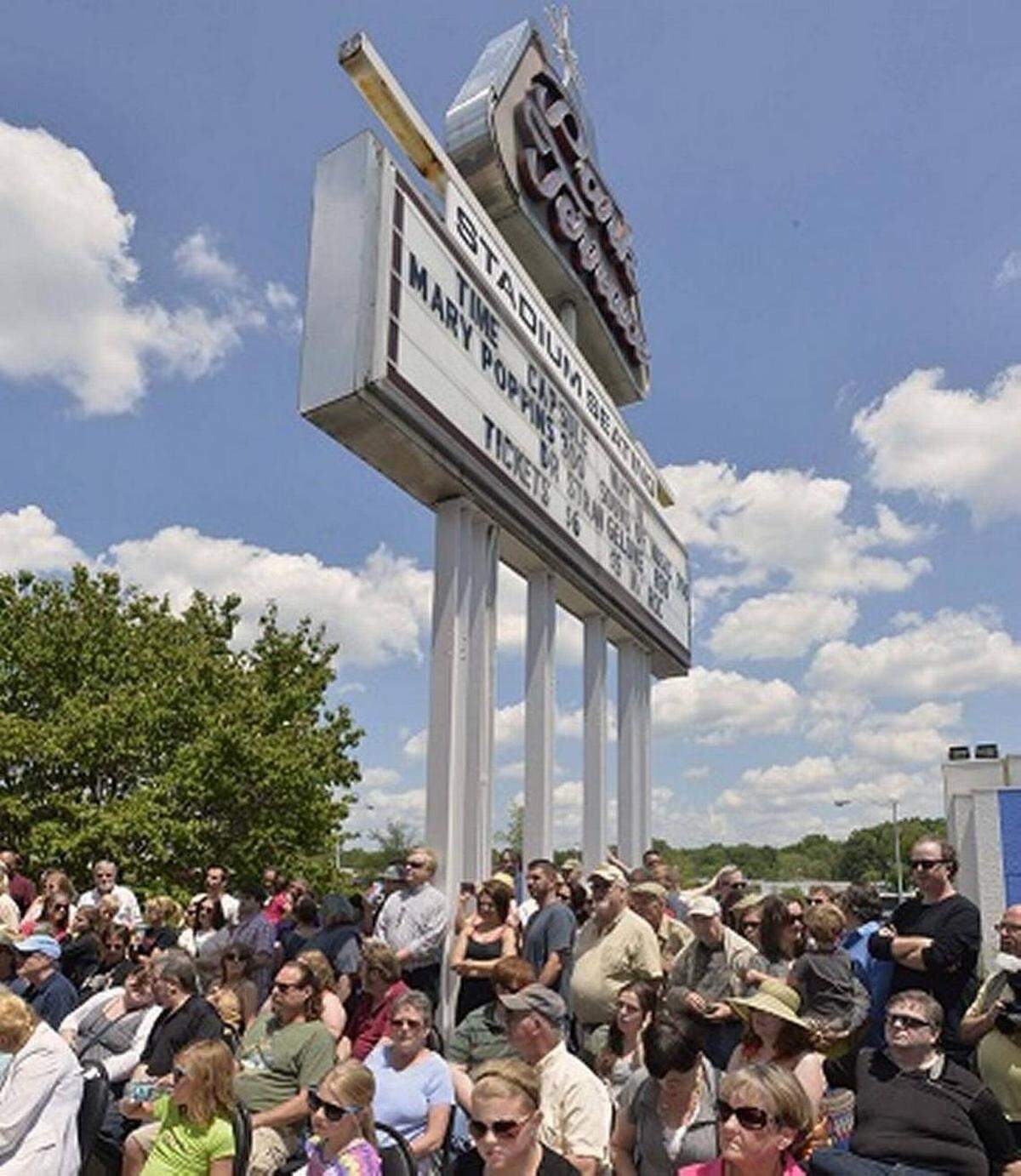 Onlookers gather during an opening on May 11, 2014 of the time capsule that was buried at Park Terrace theatre 50 years ago. Among the items inside is a letter from former Mayor Stan Brookshire, written to residents 50 years in the future. Park Terrace Stadium will close its doors after over half a century at the Park Road Shopping Center.