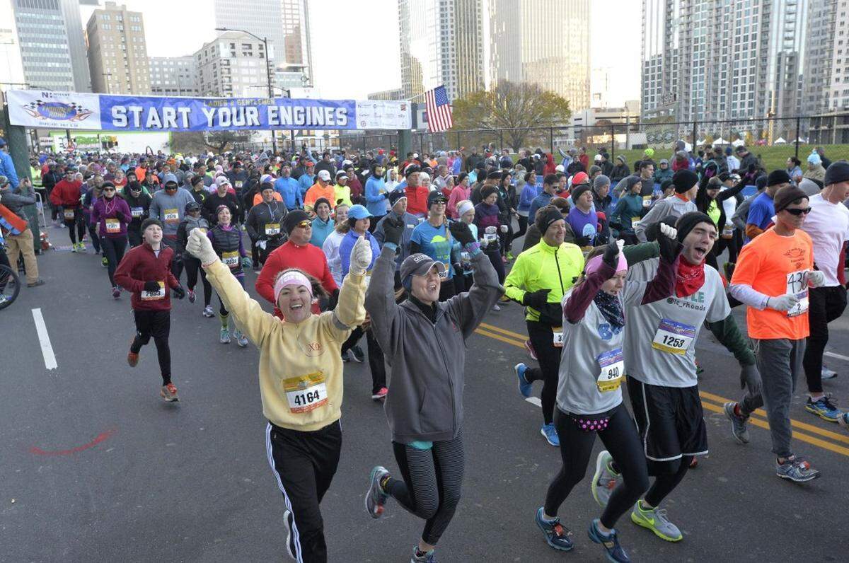 Runners take off at the start of the Thunder Road Marathon and Half-Marathon at the intersection of 4th Street and N. Graham Street in uptown on Nov. 15, 2014.