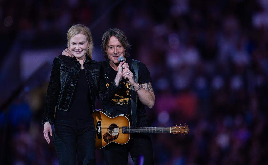 Keith Urban, right, invites his wife, Nicole Kidman on stage during Concert for Carolina in Charlotte, N.C. on Saturday, October 26, 2024.