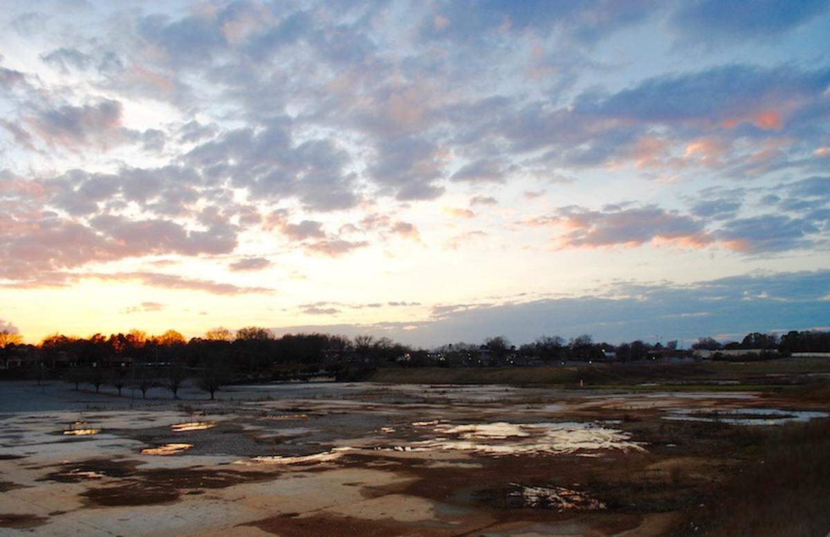 The sun sets over the land where the old Eastland Mall once stood.