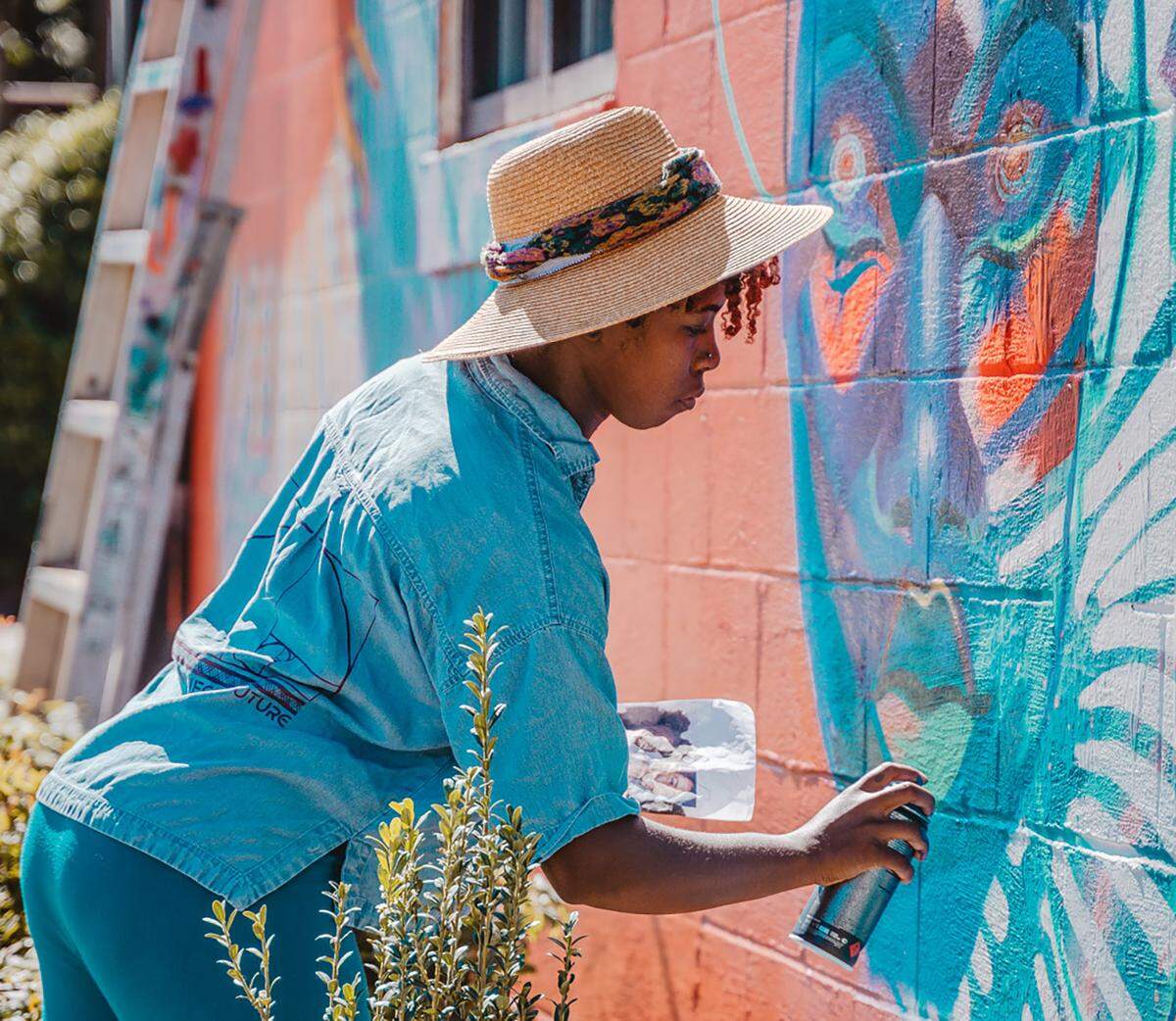 Georgie Nakima (Garden of Journey) paints at Salon 1226 during the Talking Walls festival
