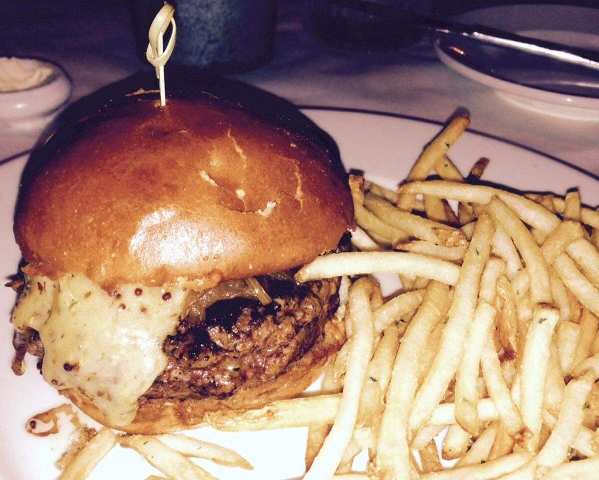 A juicy burger on a brioche bun with red dragon cheese and sriracha aoli at Georges Brasserie. MICHAEL WEINSTEINRead more here: http://www.charlotteobserver.com/entertainment/restaurants/article29546926.html#storylink=cpy