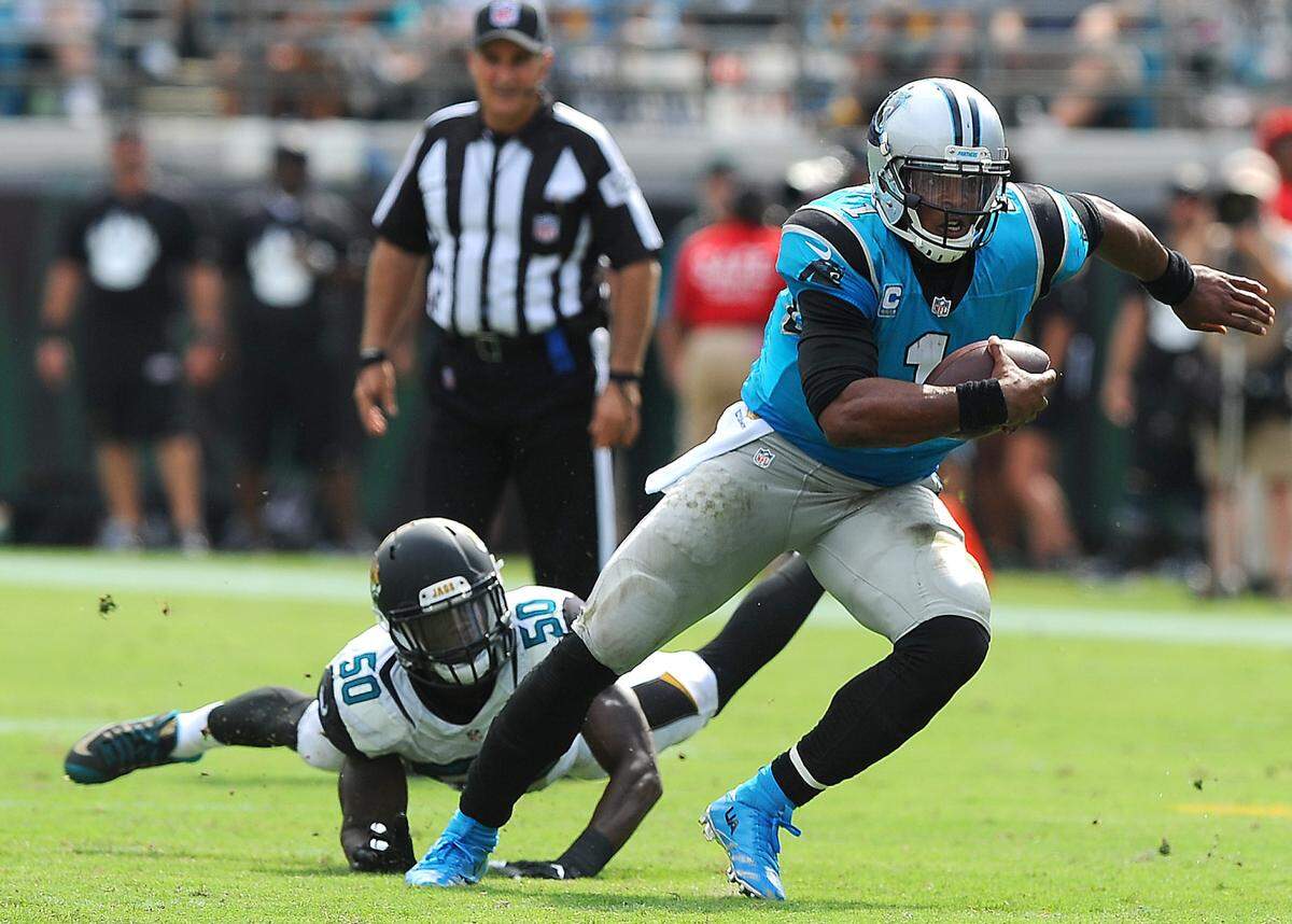 Carolina Panthers quarterback Cam Newton played for the team from 2011-19, setting almost every franchise record. Here he breaks away from a Jacksonville tackler during his 2015 NFL Most Valuable Player season.