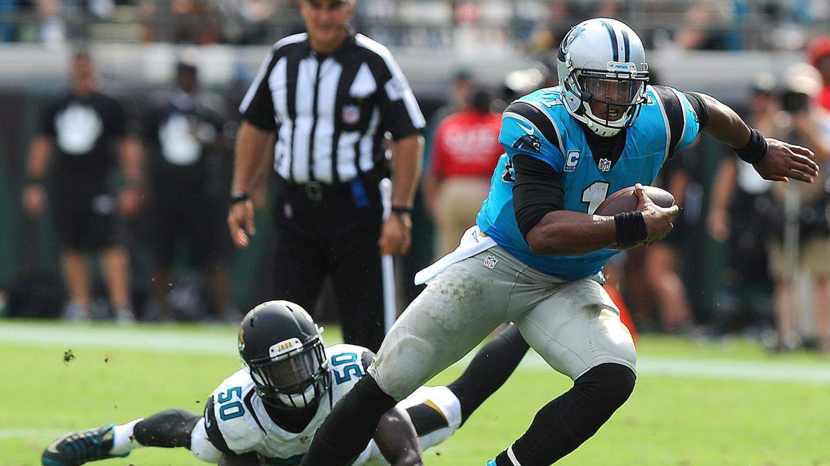 Carolina Panthers quarterback Cam Newton breaks away from Jacksonville Jaguars linebacker Telvin Smith during fourth quarter action at EverBank Field in Jacksonville, FL on Sunday, September 13, 2015. The Panthers defeated the Jaguars 20-9.
